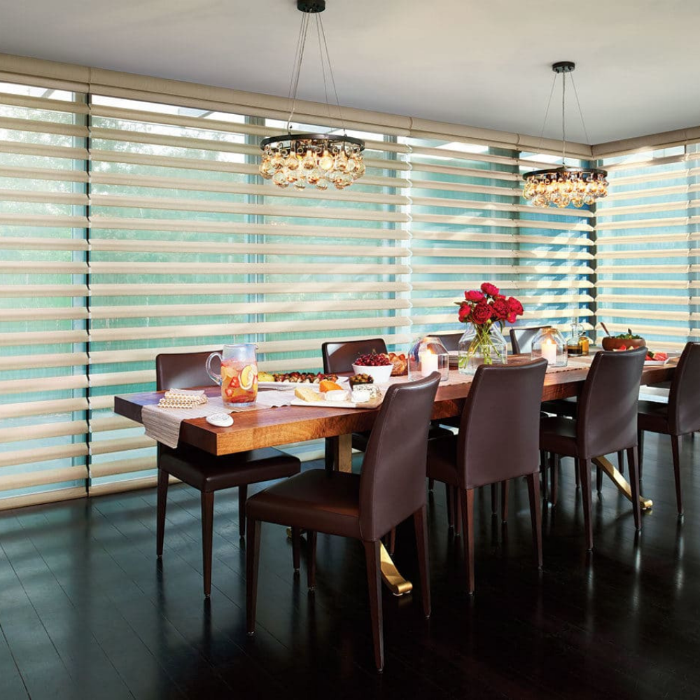 Pirouette window coverings in a dining room. Available at JC Licht