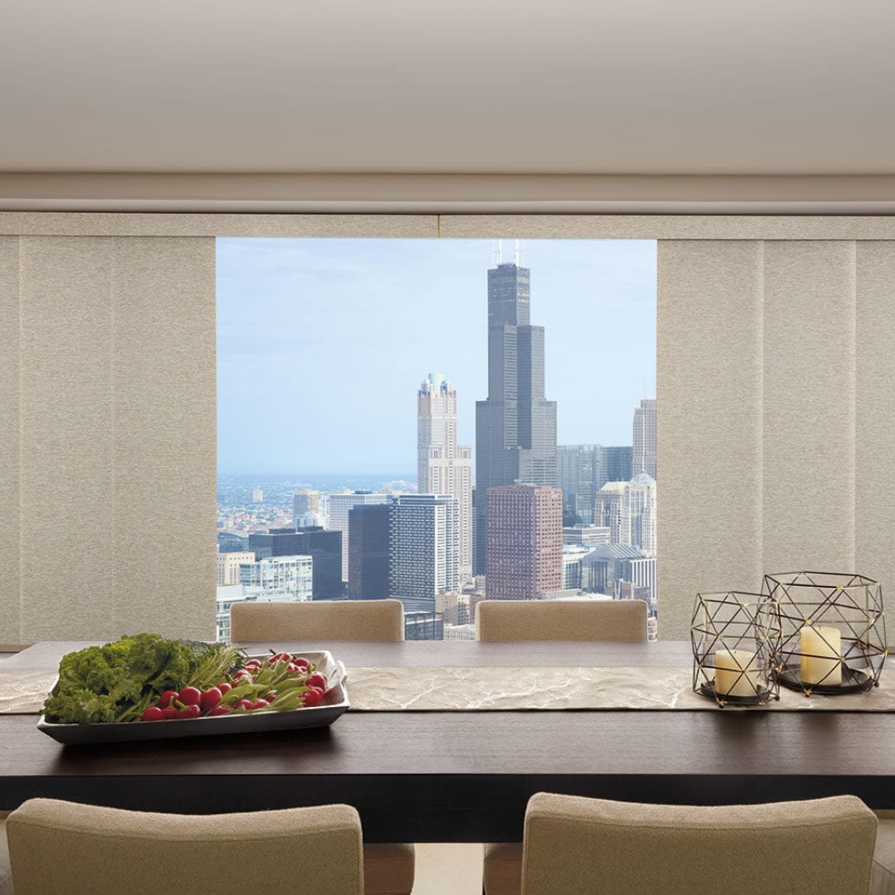 Skyline window treatments in a dining room with a view of a city. Available at JC Licht in Chicago, IL.