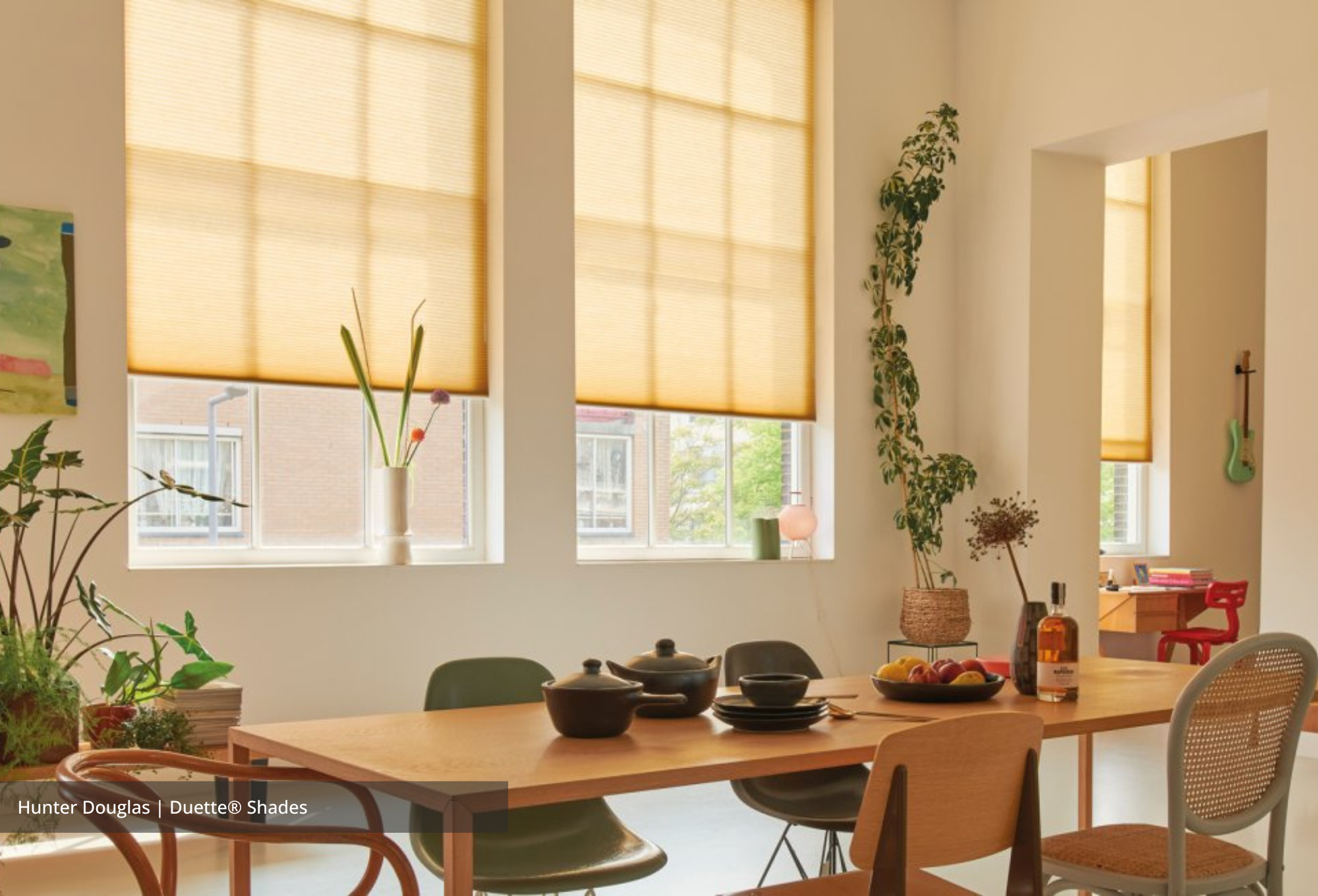 Decorate your home with color trends 2023 using gold curtains from Hunter Douglas at JC Licht. 