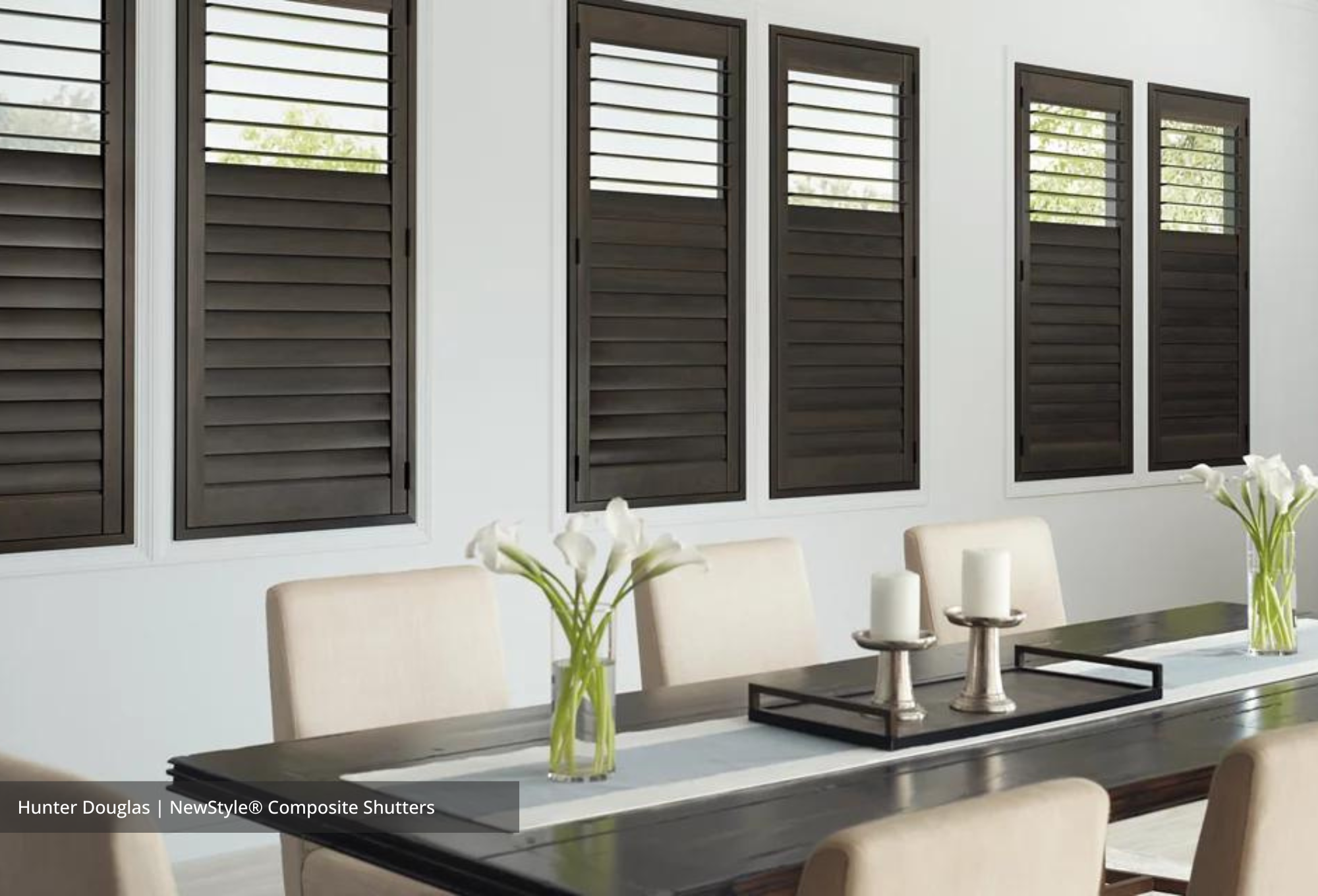 Hardwood shutters on large windows in a living room 