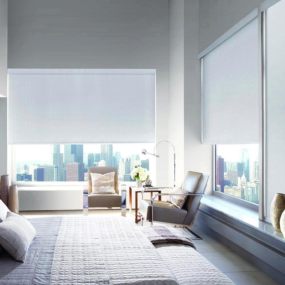 Designer Roller Shades in a window filled bedroom. Available at JC Licht in Chicago, IL