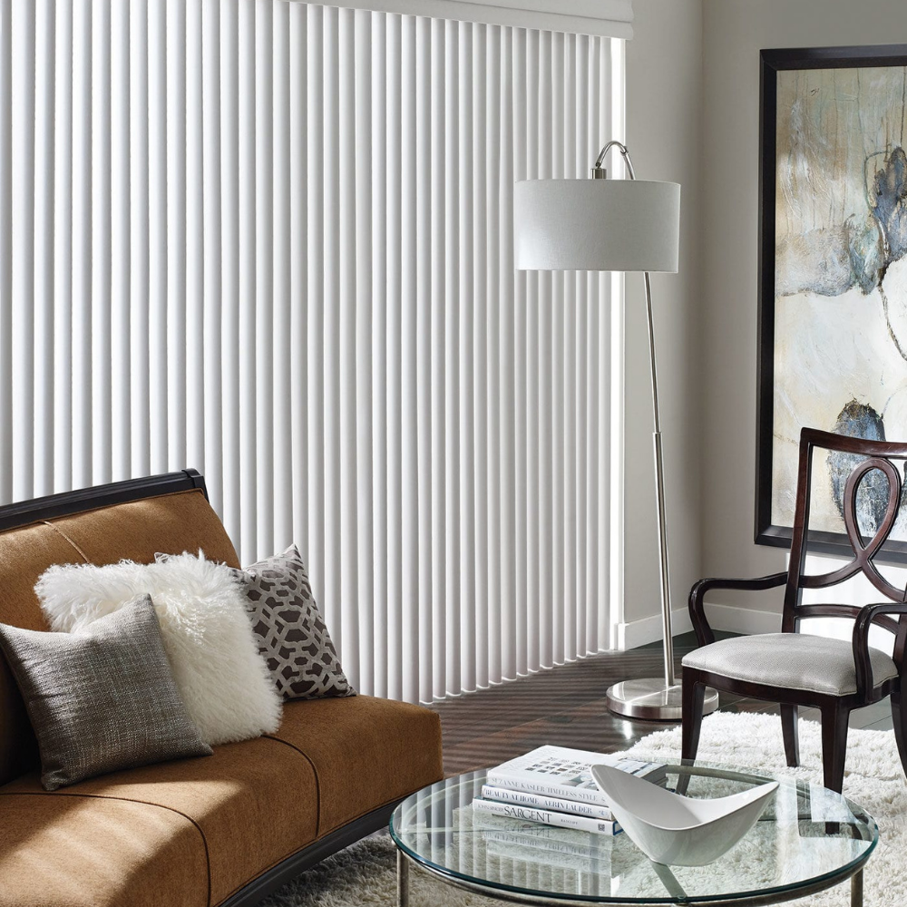 Cadence Vertical Blinds in purple compliment the chair and room decor. Available at JC Licht in Chicago, IL
