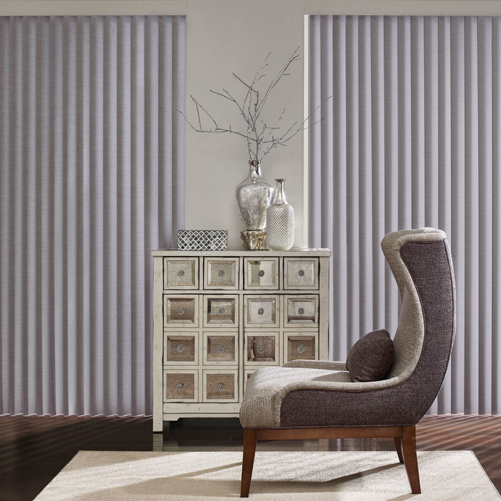 Cadence Vertical Blinds in purple compliment the chair and room decor. Available at JC Licht in Chicago, IL
