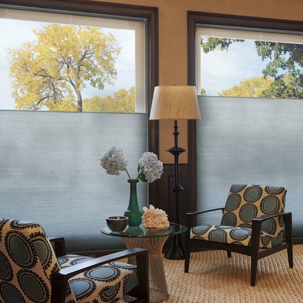 A sitting room with grey Duette window coverings half open. Available at JC Licht in Chicago, IL