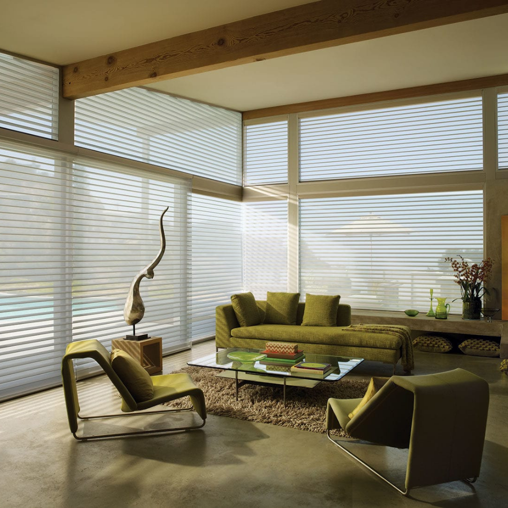 Nantucket window treatments in a living room with green furniture. Available at JC Licht in Chicago, IL