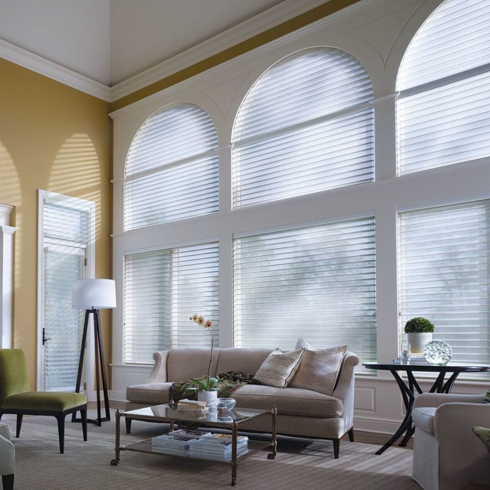 Nantucket window treatments in a living room with arched windows. Available at JC Licht in Chicago, IL