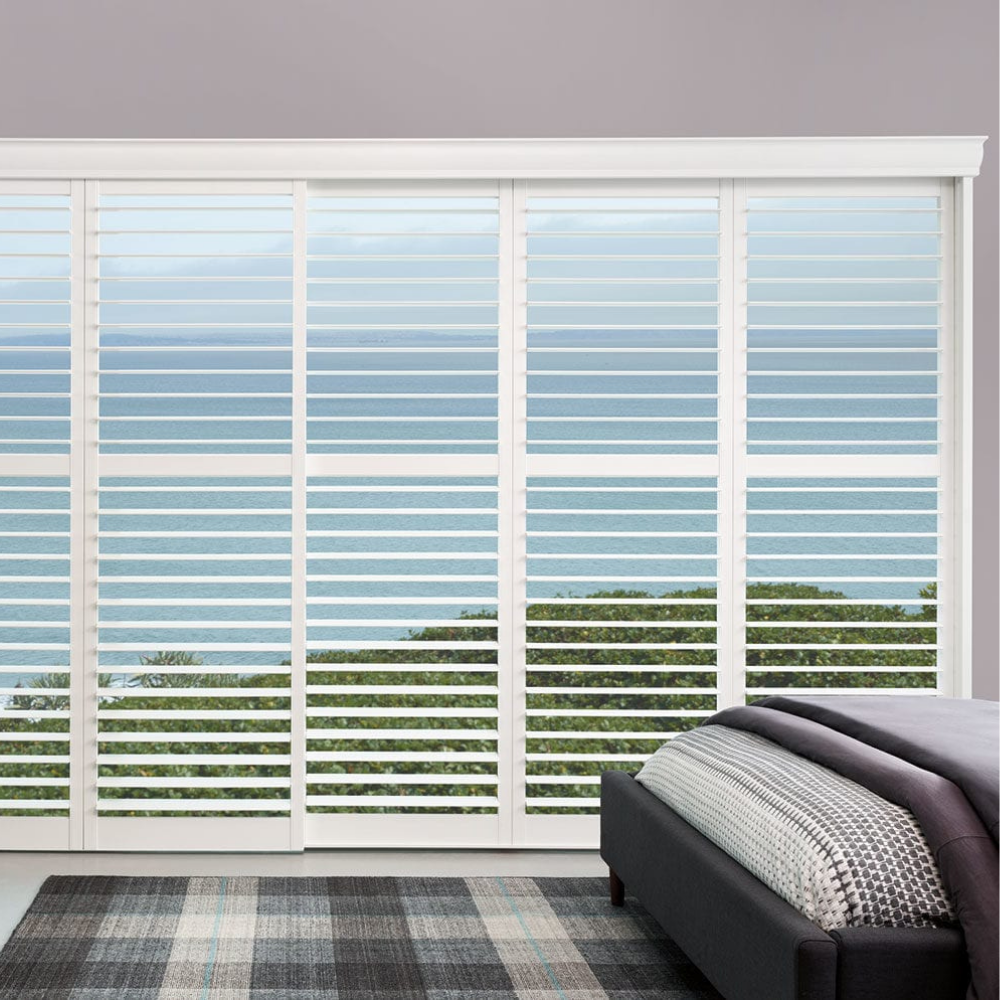 Palm Beach window shutters in a ocean view bedroom available at JC Licht in Chicago, IL