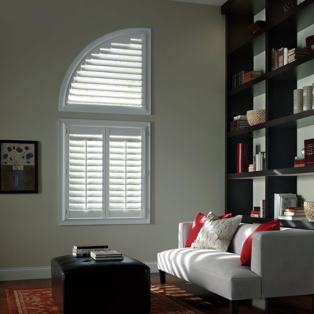 Custom half-arch Palm Beach window shutters in a living room. Available at JC Licht in Chicago, IL