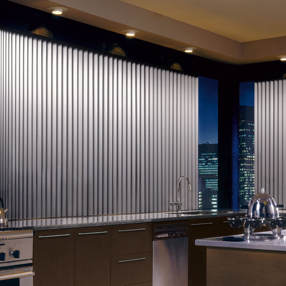 Window filled kitchen with dramatic Somner window coverings. Available at JC Licht in Chicago, IL