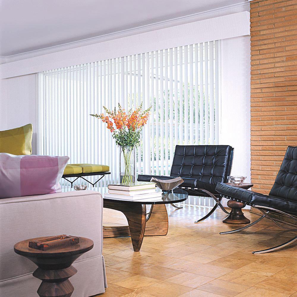 Large living room window covered with Hunter Douglas Vertical Solutions. Available at JC Licht in Chicago, IL
